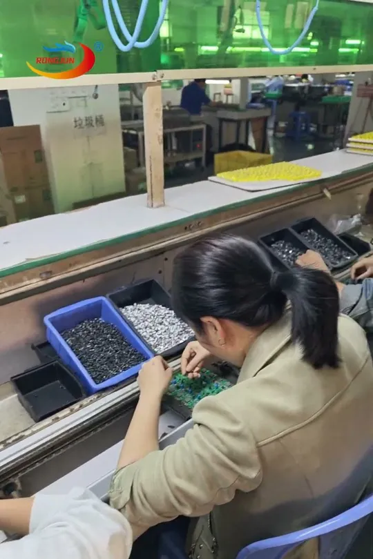 Worker on the GaN charger assembly line, from our factory video